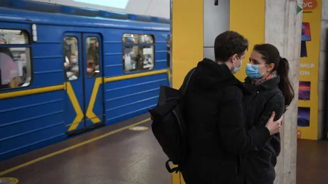 A couple at a train station in Kyiv