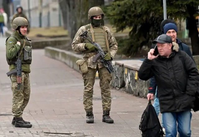 Ukrainian Military Forces servicemen stand guard in the so-called government quarter in Kyiv