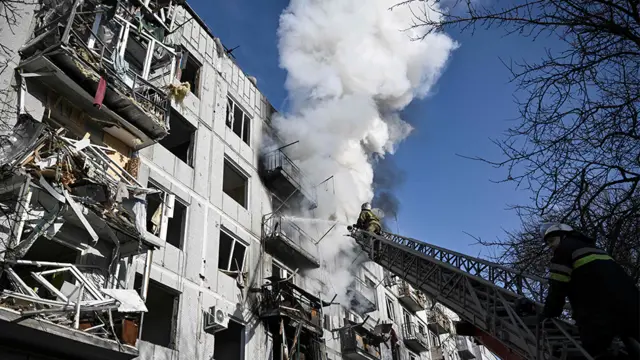 Firefighters tackle a fire after bombings in the eastern Ukraine town of Chuguiv