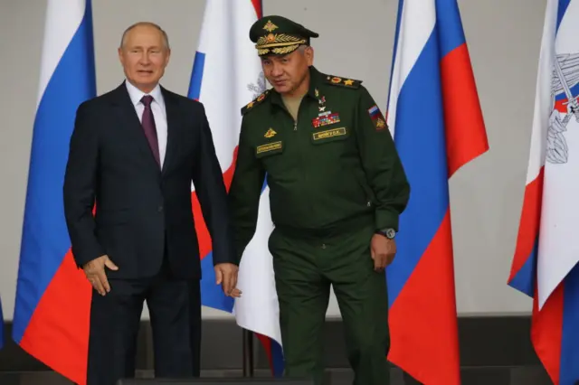 Russian President Vladimir Putin (L) and Defence Minister Sergei Shoigu