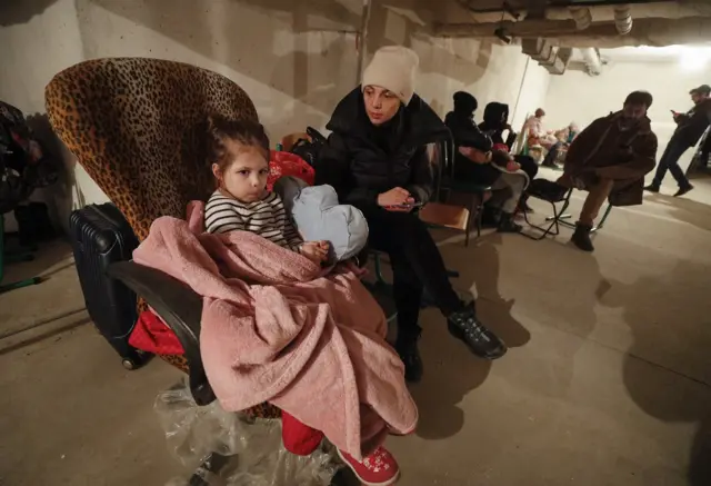 Woman and little girl in underground metro station in Kyiv, Ukraine