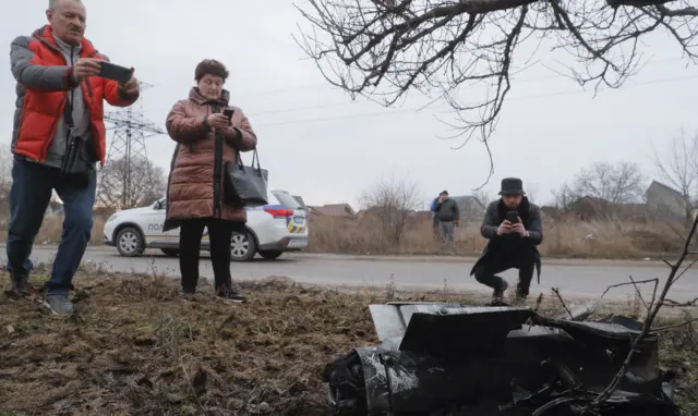 Kyiv residents stop to take photos of rocket debris