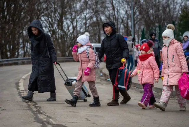 Ukrainian women and children leave Ukraine after crossing the Slovak-Ukrainian border