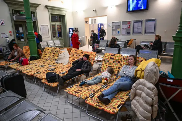 Ukrainian citizens take an overnight rest in a temporary shelter after arriving in a train from Kiev at Przemysl main train station