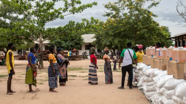 Internally displaced persons await in line during an United Nations World Food Program's distribution at a school in Matuge district, northern Mozambique - February 2021