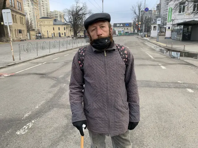 Man with a cane in a hat with beard