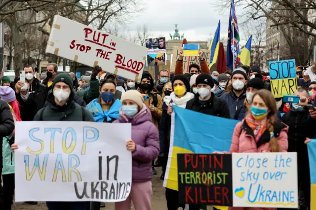 Demonstrators gather in front of the Brandenburg gate in Berlin, Germany