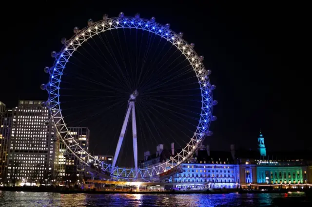 The colours of the Ukrainian flag are shown on the London Eye in central London, on February 25, 2022, to show solidarity with the people of Ukraine following Russia's invasion of the country.