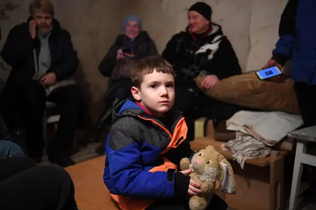 A five year old holds a puppet as he wait in an undergound shelter during bombing alert in the Ukrainian capital of Kyiv - 26 February 2022