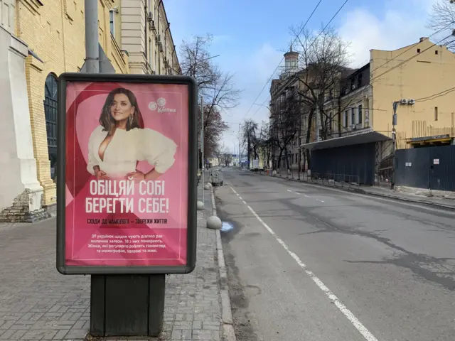 Empty road with advertising billboard in foreground