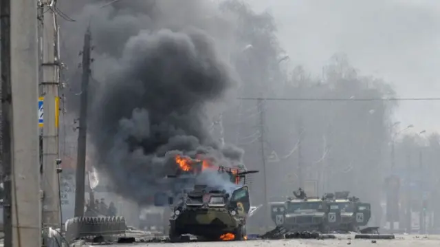 A Russian Armoured personnel carrier (APC) burning in Kharkiv