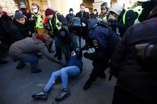 Protester being detained