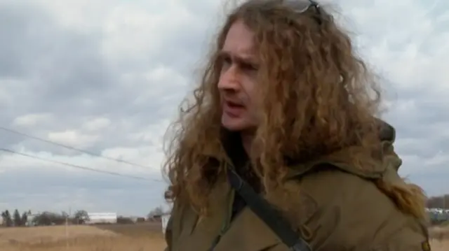 A Polish man waiting for his friend to walk 25km from Ukraine to the border