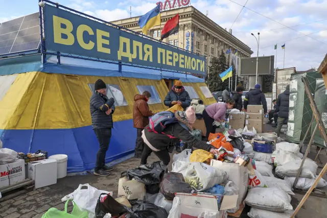 Ukrainians collect humanitarian aid in the city of Kharkiv, Ukraine, 27 February 2022.