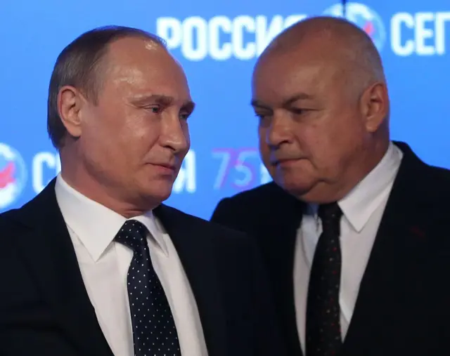 Dmitry Kiselyov, right, and Putin in 2016