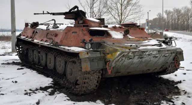 A destroyed Russian military vehicle is seen on the roadside on the outskirts of Kharkiv on February 26, 2022.