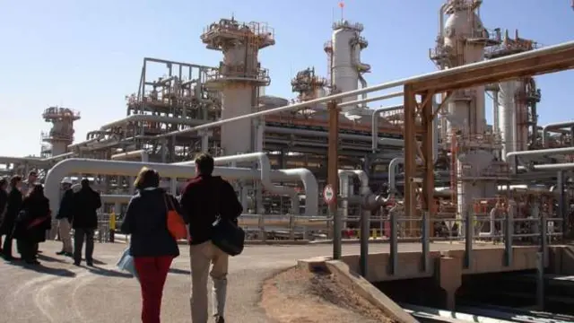 People walking through a gas plant