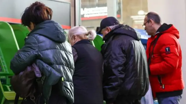 People use Sberbank ATM machines at the Kazansky railway station.