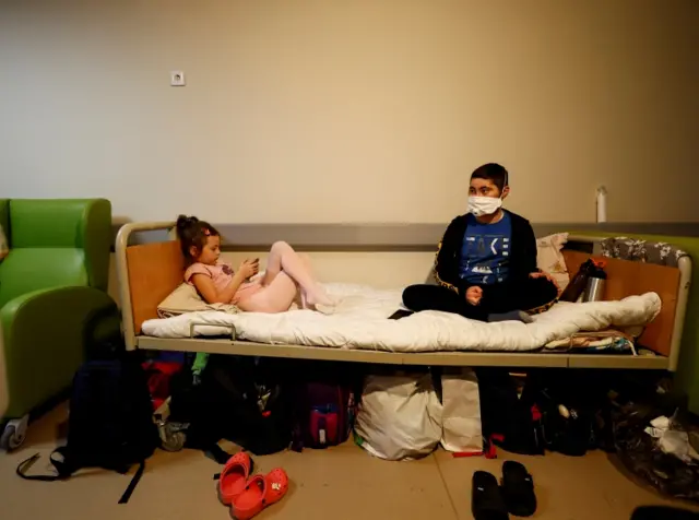 Children patients whose treatments are underway stay in their beds moved to the hallways of basement floors of Okhmadet Children's Hospital, as Russia