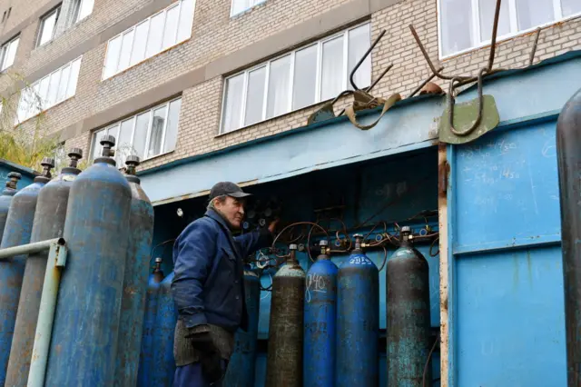 worker is seen servicing oxygen cylinders for Covid-19 patients in Kramatorsk city hospital, in November 2021.