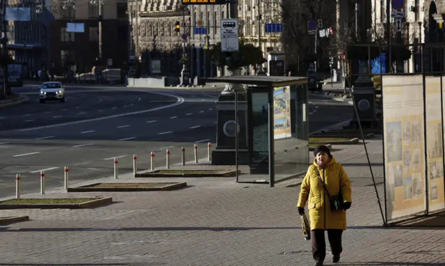 A person walks on a street after the curfew was lifted in Kyiv