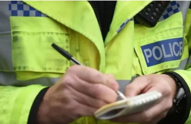 Police officer making notes.