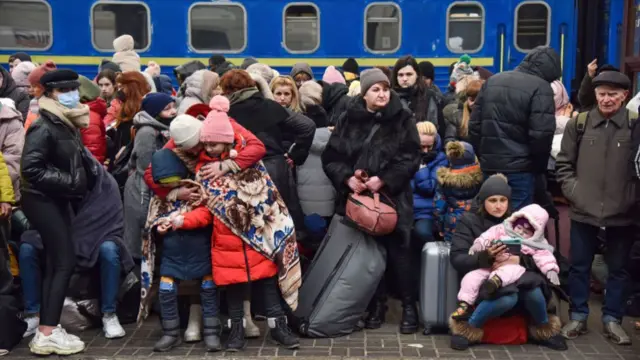 Refugees on the platform of Lviv railway station in Ukraine waiting for trains to Poland