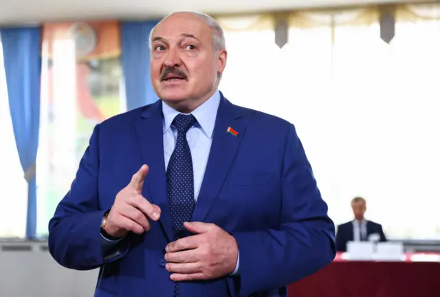 Belarusian President Alexander Lukashenko talks to reporters at a polling station after casting his vote in the 2022 Belarusian constitutional referendum.