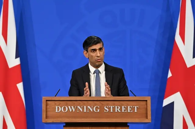 Rishi Sunak speaking to reporters