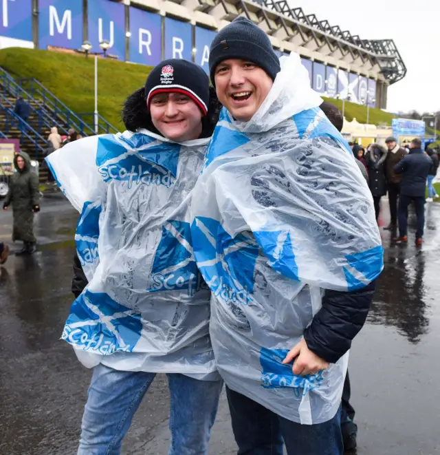 These fans are in good spirits despite the cold, wet weather