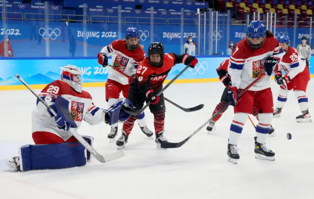 Japan and Czech Republic players competing for the puck