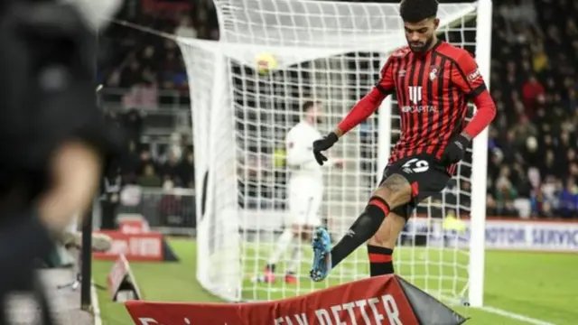 Philip Billing boots an advertising hoarding