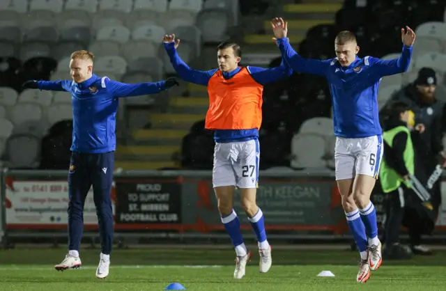 Three St Johnstone players warm-up before the game