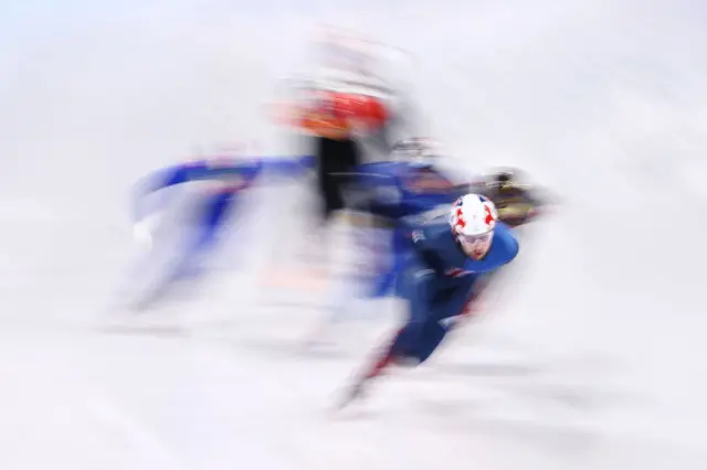 Short track speed skating race in blurry focus