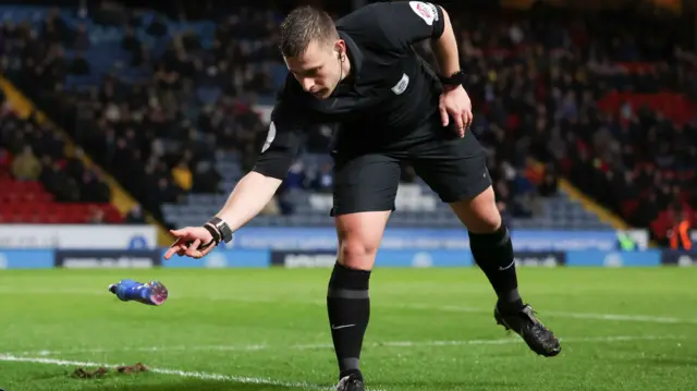 Referee clears bottle