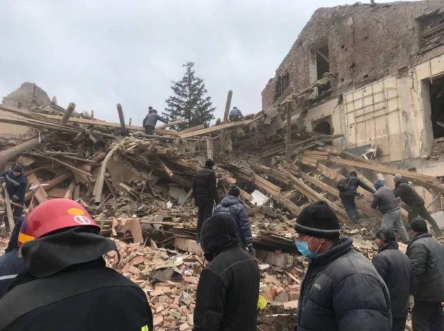 Rescuers look for bodies amid the rubble