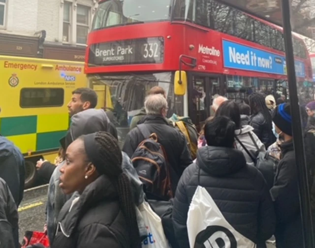 people queuing for buses