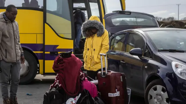 African family standing by luggage