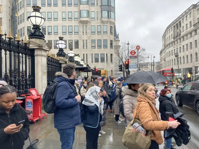 Queues for buses at Charing Cross station