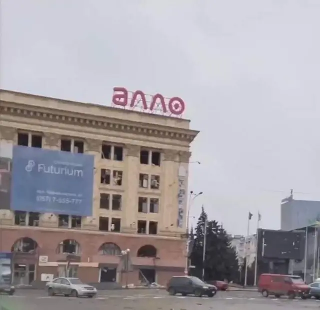 Burnt out cars with damaged windscreens in the square that was just blasted by a Russian missile