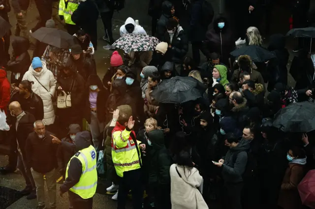 People wait to get on buses at outside a central London Tube station during the strike