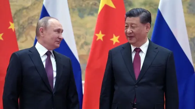 Russian President Vladimir Putin (L) and Chinese President Xi Jinping pose for a photograph during their meeting in Beijing, on February 4, 2022.