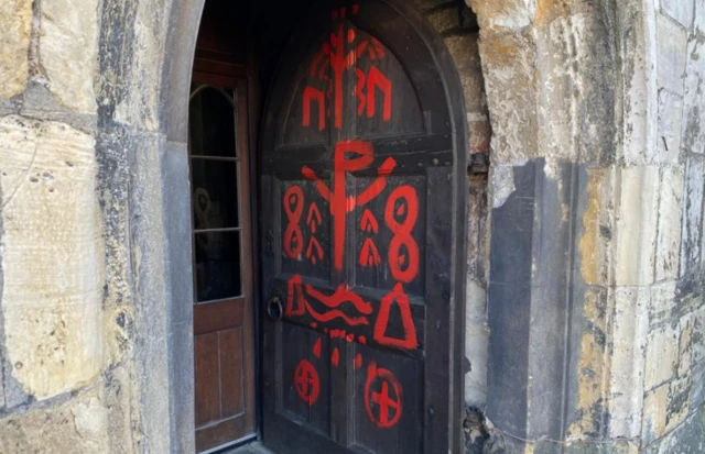 Graffiti on door of St Olave's.