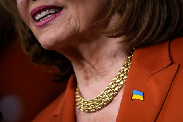 Top Democrat Nancy Pelosi wears a Ukraine flag on her lapel in a news briefing