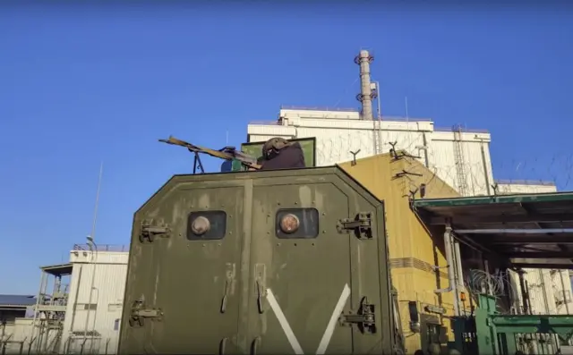 A still image taken from a handout video made available by the Russian Defence Ministry press service shows Russian servicemen guard in front of the Chernobyl Nuclear Power Plant in Pripyat, Ukraine, 07 March 2022.