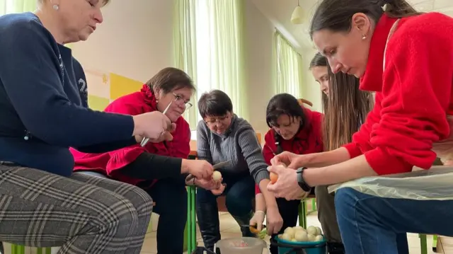 Women prepare vegetables