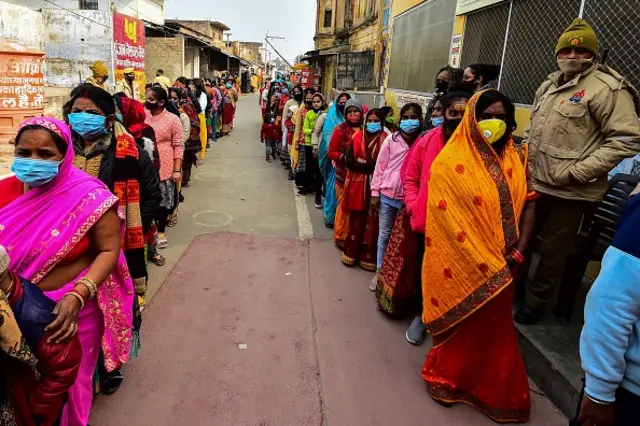 Devotees in a queue to offer prayers to Hindu deity Ram next to the under-construction site for a temple to Ram in Ayodhya.