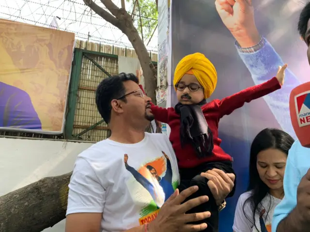 A child dressed up as AAP chief Arvind Kejriwal wearing turban and muffler and sporting a fake moustache.