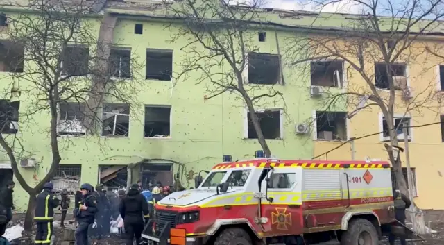 Emergency services are seen on site of the destroyed Mariupol children"s hospital