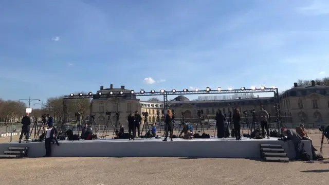 TV journalists lined up on a stage in Versailles, France before an EU summit